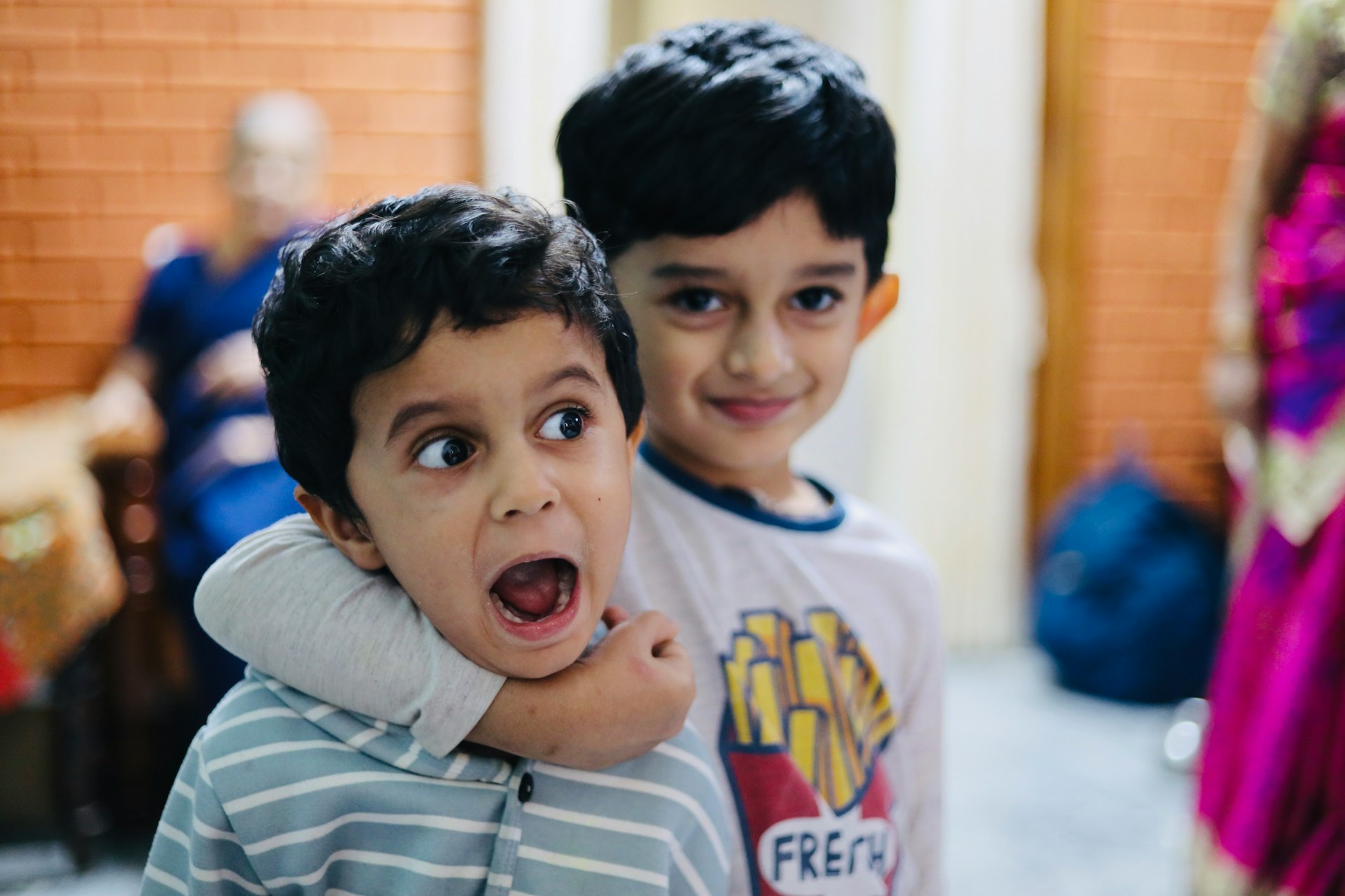 two young boys standing next to each other